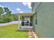 Backyard view of screened lanai area overlooking a well-maintained grassy yard at 2721 Walden Woods Dr, Plant City, FL 33566