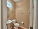 A half bathroom with a stylish sink, mirror, toilet, and neutral wall color at 2721 Walden Woods Dr, Plant City, FL 33566