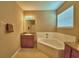 Bathroom featuring a large soaking tub, single sink, and neutral colored walls at 2721 Walden Woods Dr, Plant City, FL 33566