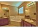 Bathroom featuring a large soaking tub, double sinks, and neutral colored walls at 2721 Walden Woods Dr, Plant City, FL 33566
