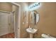 A half bathroom with neutral wall color, stylish sink, mirror, and white toilet at 2721 Walden Woods Dr, Plant City, FL 33566