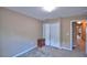 This neutral bedroom has carpeted floors, a closet, and a dark wood accent table at 2721 Walden Woods Dr, Plant City, FL 33566