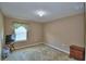 Cozy carpeted bedroom features a large window for natural light and neutral wall color at 2721 Walden Woods Dr, Plant City, FL 33566