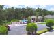 A view of the community pool area with lush landscaping, covered seating, and dedicated parking at 2721 Walden Woods Dr, Plant City, FL 33566