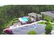 A community pool with a covered lounge area and ample parking is surrounded by lush greenery at 2721 Walden Woods Dr, Plant City, FL 33566