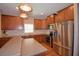 A kitchen featuring wooden cabinets, stainless steel appliances, and pendant lighting fixtures at 2721 Walden Woods Dr, Plant City, FL 33566