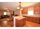 Kitchen and dining area with wood floors, wooden cabinets, stainless appliances, and table at 2721 Walden Woods Dr, Plant City, FL 33566