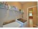 Bright laundry room features modern washer and dryer with shelving and plenty of cleaning supplies at 2721 Walden Woods Dr, Plant City, FL 33566