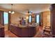 Spacious living room with hardwood floors, fireplace, ceiling fan, comfortable leather sofa, and elegant decor at 2721 Walden Woods Dr, Plant City, FL 33566