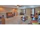 Spacious living room with plush carpeting, leather furniture, and neutral color palette perfect for relaxation at 2721 Walden Woods Dr, Plant City, FL 33566