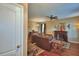 Spacious living room with hardwood floors, ceiling fan, fireplace, and comfortable leather furniture at 2721 Walden Woods Dr, Plant City, FL 33566