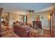 Inviting living room with hardwood floors, fireplace, ceiling fan, and comfortable leather sofa at 2721 Walden Woods Dr, Plant City, FL 33566