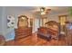 Main bedroom featuring a ceiling fan, dresser, bench, and hardwood floors at 2721 Walden Woods Dr, Plant City, FL 33566