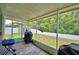 Relaxing screened patio with brick pavers, grill, and view of the backyard at 2721 Walden Woods Dr, Plant City, FL 33566