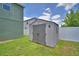 The backyard features a gray storage shed with a double door entry and lawn at 2721 Walden Woods Dr, Plant City, FL 33566