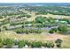 Aerial view of the townhouse complex situated near a golf course and a pond at 34852 Teeview Ln, Zephyrhills, FL 33541