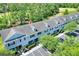Aerial view showcasing the townhouse complex and surrounding greenery at 34852 Teeview Ln, Zephyrhills, FL 33541