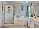 Beautiful bathroom with a shower, tub, and white vanity at 34852 Teeview Ln, Zephyrhills, FL 33541