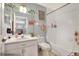 Bathroom features a vanity, mirror, toilet, and shower/tub combo at 34852 Teeview Ln, Zephyrhills, FL 33541