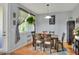 Bright dining room features a large window, modern décor, and comfortable seating for Gathering gatherings at 34852 Teeview Ln, Zephyrhills, FL 33541