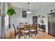 The formal dining room features a modern chandelier and offers a serene view with lush, hanging plants at 34852 Teeview Ln, Zephyrhills, FL 33541