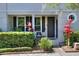 Inviting townhome exterior featuring a well-kept garden and cozy front porch at 34852 Teeview Ln, Zephyrhills, FL 33541