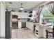 Well-lit kitchen featuring stainless steel appliances, white cabinets, and granite countertops, and tile floors at 34852 Teeview Ln, Zephyrhills, FL 33541