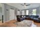 Comfortable living room with hardwood floors, ceiling fan and plenty of seating at 34852 Teeview Ln, Zephyrhills, FL 33541