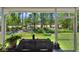 Enjoy the view from the enclosed patio with outdoor grill at 34852 Teeview Ln, Zephyrhills, FL 33541