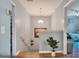 Bright foyer with hardwood stairs, chandelier, and view into bedroom at 34852 Teeview Ln, Zephyrhills, FL 33541