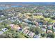Residential aerial view showing a community near a golf course, featuring pools and green spaces at 3507 Autumn Glen Dr, Valrico, FL 33596