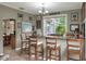 Indoor bar area featuring wooden bar stools, a view to the pool, and 'Personal Cave' sign at 3507 Autumn Glen Dr, Valrico, FL 33596