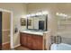 Bathroom with double sink vanity, granite counters, tile floors, and soaking tub at 3507 Autumn Glen Dr, Valrico, FL 33596
