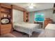 This cozy bedroom features a built-in murphy bed, bookshelves, and a ceiling fan at 3507 Autumn Glen Dr, Valrico, FL 33596