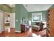 A charming bedroom features a vanity, chair and hardwood floors, and a luxurious chaise lounge for relaxation at 3507 Autumn Glen Dr, Valrico, FL 33596
