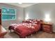 A bright bedroom features a bed with bedside tables and a window providing natural light at 3507 Autumn Glen Dr, Valrico, FL 33596