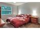 Bedroom with bedside tables, lamps and a large window at 3507 Autumn Glen Dr, Valrico, FL 33596
