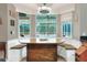 Cozy breakfast nook featuring a built-in bench, table, and large windows with a pool view at 3507 Autumn Glen Dr, Valrico, FL 33596
