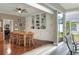 Bright dining area features hardwood floors, custom built-ins, and large glass door leading to outdoor spaces at 3507 Autumn Glen Dr, Valrico, FL 33596