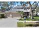 Inviting two-story home with well-manicured lawn, mature trees, and a three-car garage at 3507 Autumn Glen Dr, Valrico, FL 33596