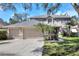 Beautiful home with a three-car garage, mature trees and an American flag in the front yard at 3507 Autumn Glen Dr, Valrico, FL 33596