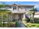 Inviting front entrance with manicured landscaping, a mature palm tree and an American flag at 3507 Autumn Glen Dr, Valrico, FL 33596
