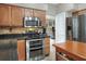 Well-equipped kitchen features stainless steel appliances and an island with storage baskets at 3507 Autumn Glen Dr, Valrico, FL 33596