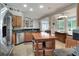 Bright eat-in kitchen features wood cabinets, black countertops, stainless appliances, and island, connecting to a sunny breakfast nook at 3507 Autumn Glen Dr, Valrico, FL 33596