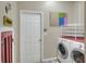Bright laundry room featuring a washer and dryer and convenient access to the back door at 3507 Autumn Glen Dr, Valrico, FL 33596