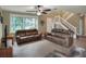 Cozy living room featuring tile floors, two reclining sofas, and a large window for natural light at 3507 Autumn Glen Dr, Valrico, FL 33596