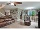 Open-concept living room with tile flooring, a comfortable couch and a bar area with seating at 3507 Autumn Glen Dr, Valrico, FL 33596
