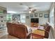 Inviting living room with leather furniture, a ceiling fan, and views to the outdoor bar at 3507 Autumn Glen Dr, Valrico, FL 33596