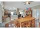 Open-concept living space connecting the kitchen, breakfast nook, and dining room with hardwood floors and natural light at 3507 Autumn Glen Dr, Valrico, FL 33596