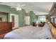 View of the main bedroom with ensuite bathroom features hard wood floors and neutral walls at 3507 Autumn Glen Dr, Valrico, FL 33596